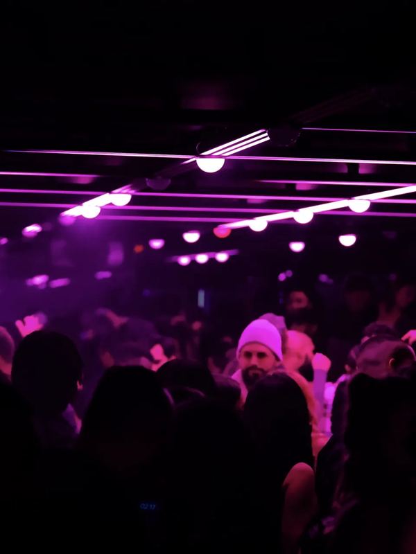 Purple-lit DJ booth at Infinity Room in Toronto